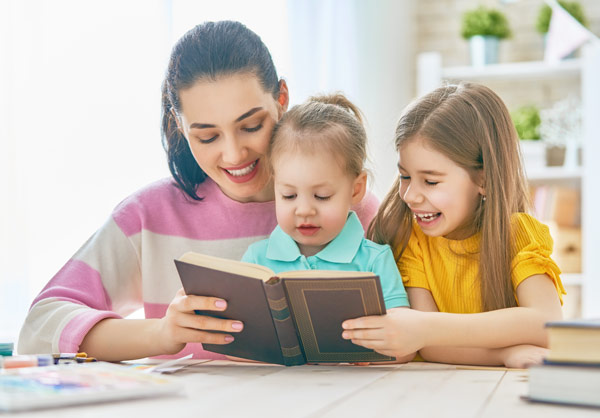 Children and Mother reading book. Happy. International Children's Book day